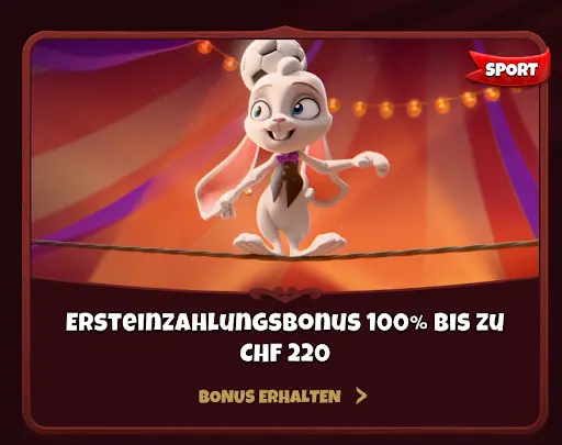 Weißes Kaninchen balanciert auf einem Seil mit Fußball auf dem Kopf, Zirkuslichter im Hintergrund, daneben Text „Ersteinzahlungsbonus 100% bis zu CHF 220“.